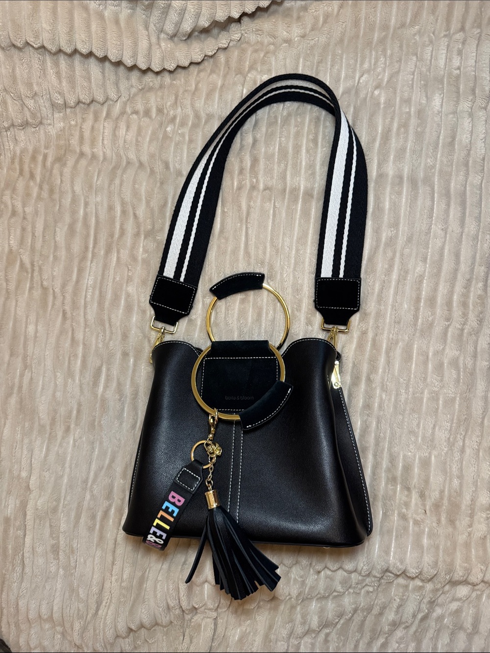 Structured Black Shoulder Bag with Gold Ring Handles and Tassel Charm